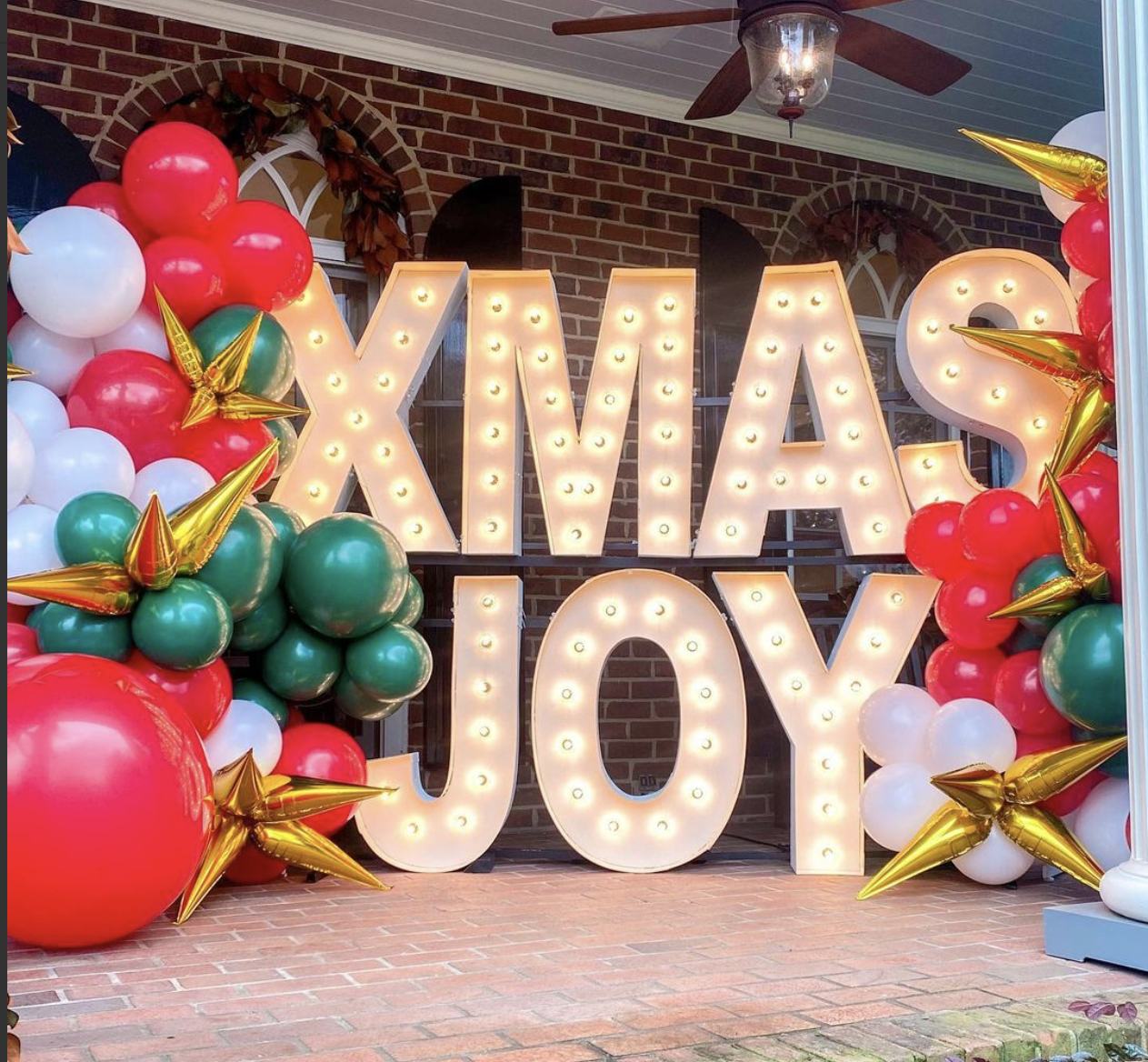 Office Christmas Party Themes, light up letters with red and green balloons and gold stars