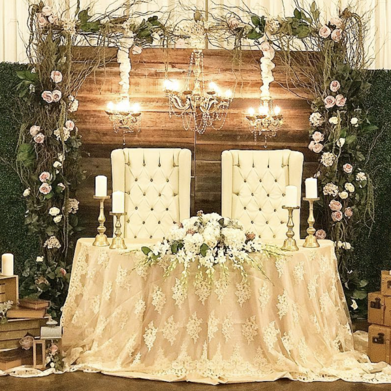 Vintage Decor Wedding Tips, a lace covered ceremony table with flowers, candles, wooden crates and a flower wall back drop